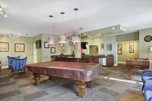a dining room with furniture and wooden floor