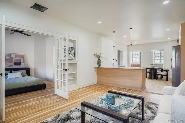 a living room with furniture and a wooden floor