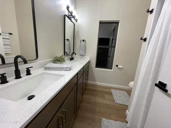 a bathroom with a double vanity sink and mirror