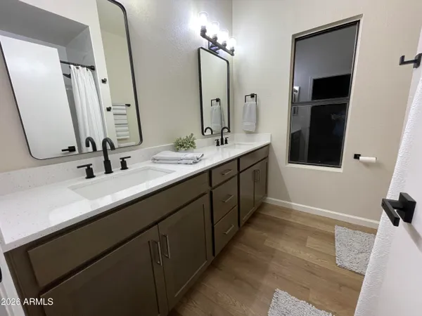 a bathroom with a double vanity sink a and mirror
