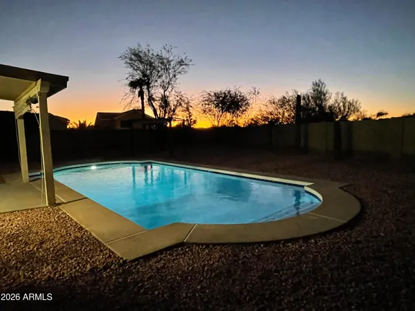 a view of a swimming pool with a yard