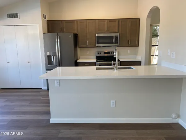 a kitchen with appliances a refrigerator and a stove