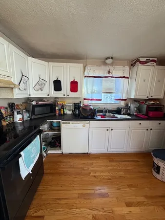 a kitchen with stainless steel appliances granite countertop a sink and a stove