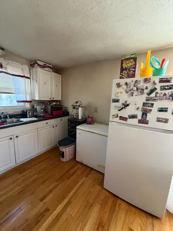 a kitchen with stainless steel appliances a stove a sink and a refrigerator