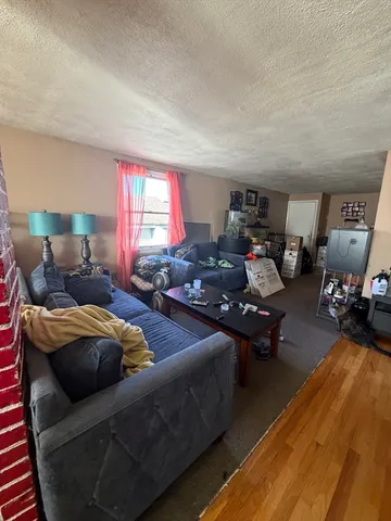 a bedroom with a bed and a potted plant