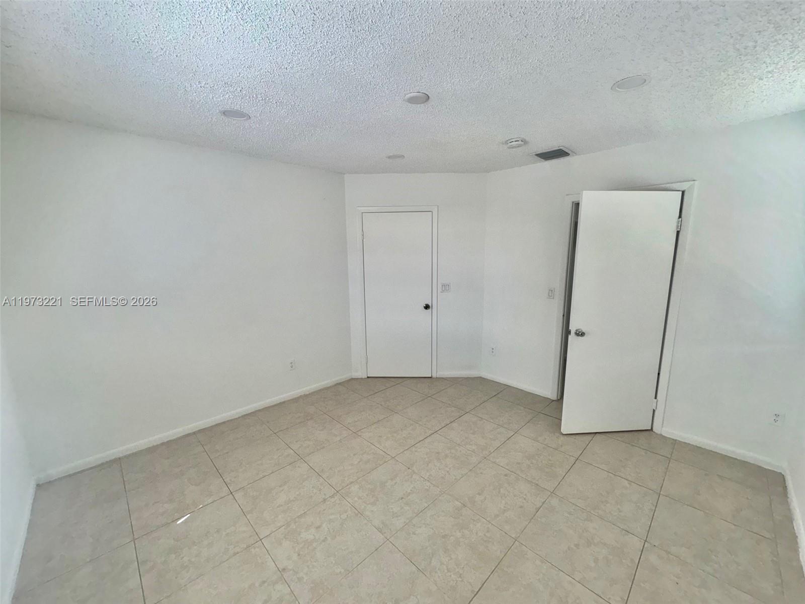 18324 Northwest 68th Avenue, Unit H Hialeah, FL 33015 - Photo 5 of 9 a view of an empty room