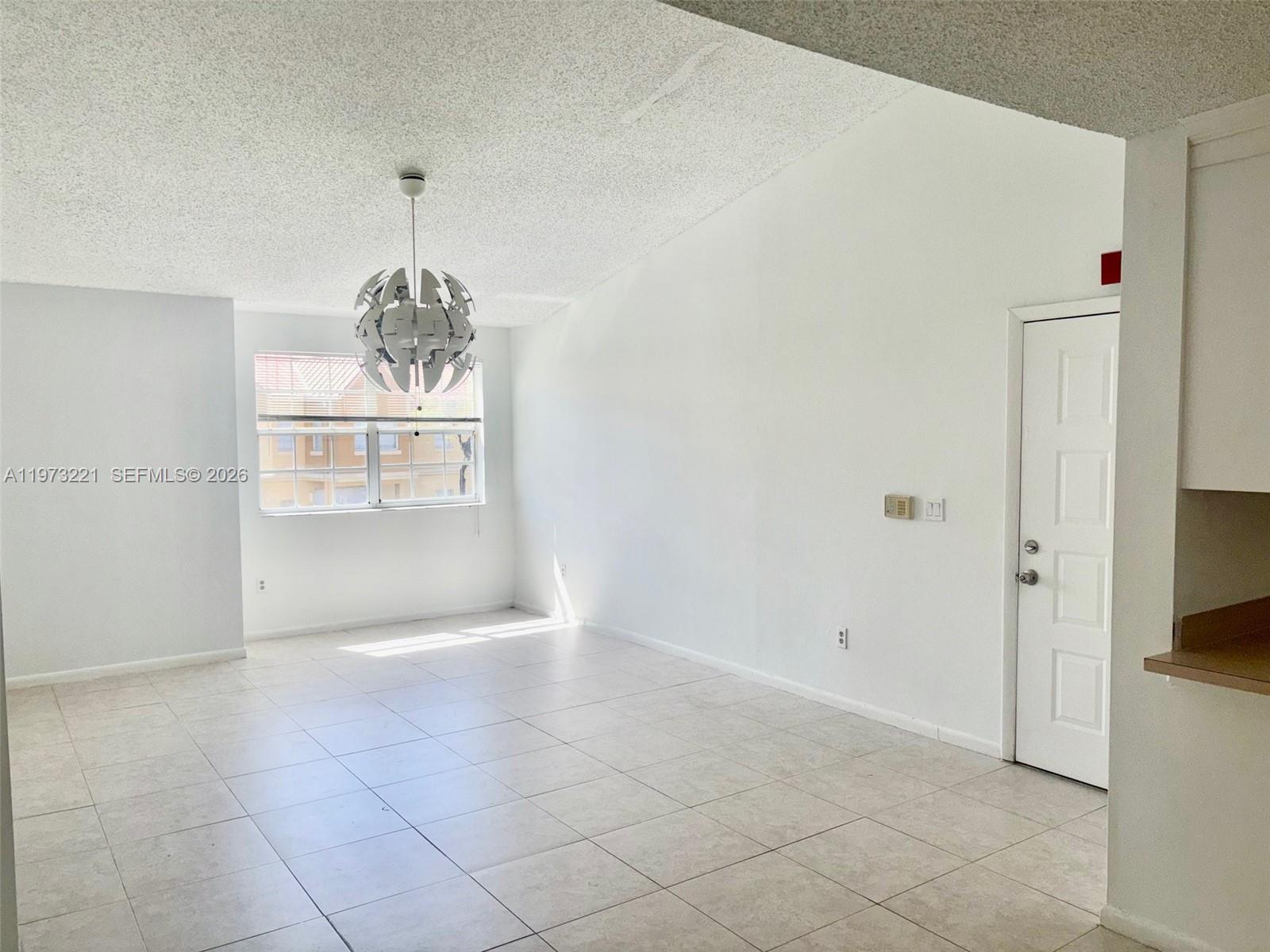 18324 Northwest 68th Avenue, Unit H Hialeah, FL 33015 - Photo 8 of 9 a view of a livingroom with an empty space