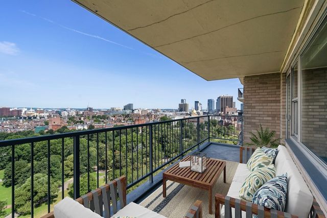 a view of a balcony with furniture