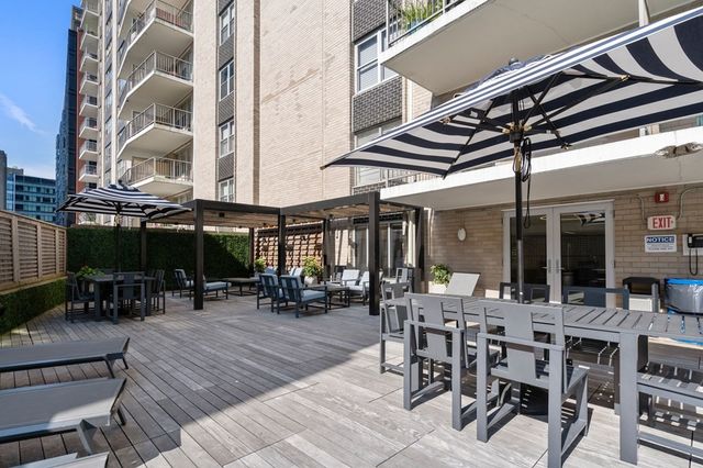 a view of a patio with table and chairs and wooden floor
