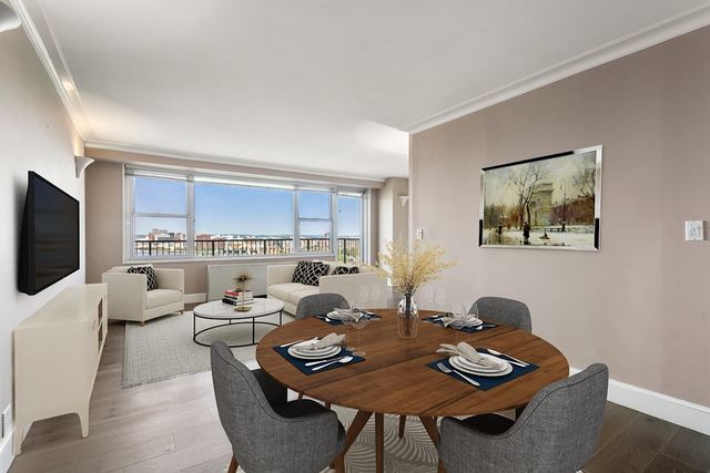 a living room with furniture a rug and a flat screen tv