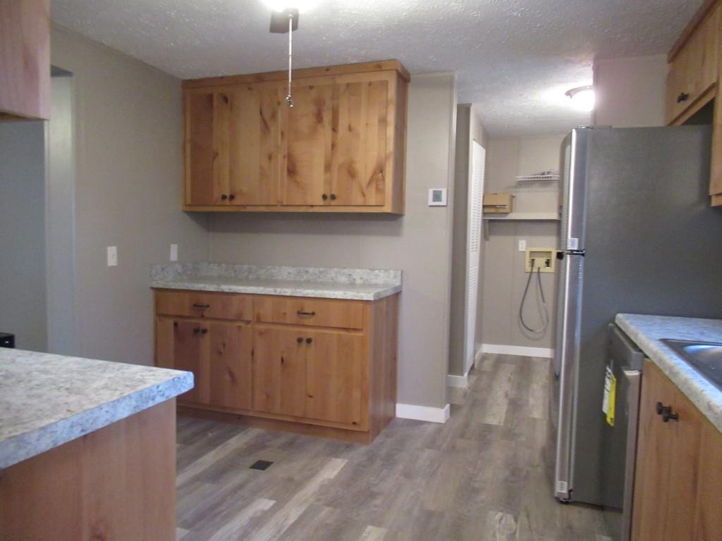 61 Berry Patch Lane Cleveland, GA 30528 - Photo 11 of 23 a kitchen with stainless steel appliances granite countertop a refrigerator a sink and a stove
