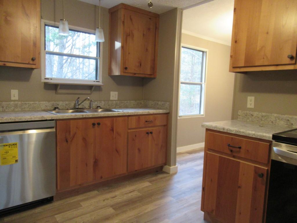 61 Berry Patch Lane Cleveland, GA 30528 - Photo 12 of 23 a kitchen with stainless steel appliances granite countertop a sink a stove a refrigerator wooden floor and cabinets