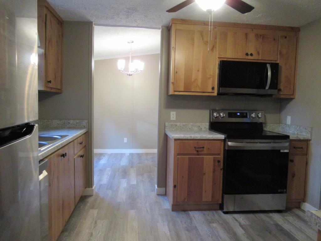 61 Berry Patch Lane Cleveland, GA 30528 - Photo 15 of 23 a kitchen with stainless steel appliances a stove a microwave and sink