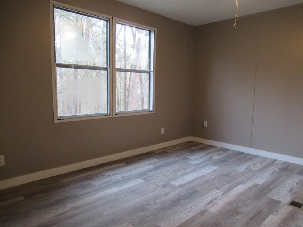 61 Berry Patch Lane Cleveland, GA 30528 - Photo 16 of 23 an empty room with wooden floor and windows