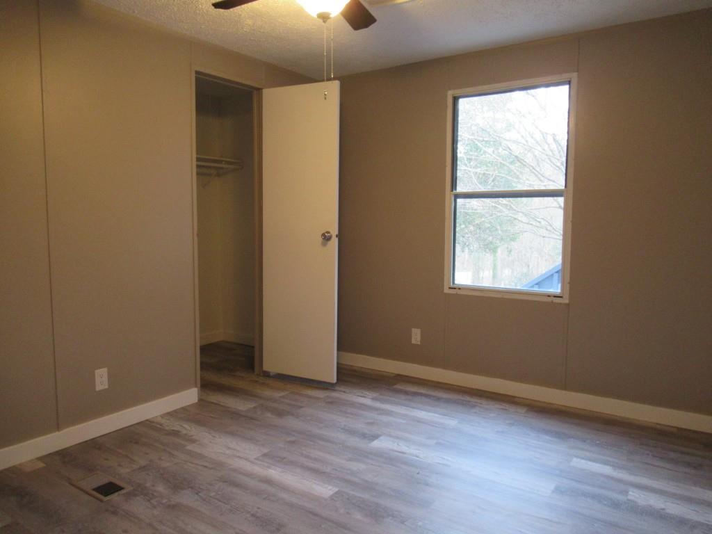 61 Berry Patch Lane Cleveland, GA 30528 - Photo 22 of 23 an empty room with wooden floor and windows