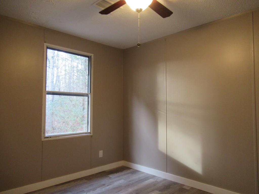 61 Berry Patch Lane Cleveland, GA 30528 - Photo 23 of 23 an empty room with wooden floor and windows