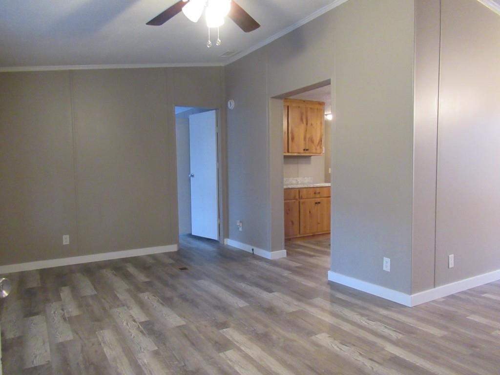 61 Berry Patch Lane Cleveland, GA 30528 - Photo 9 of 23 a view of an empty room with wooden floor and a ceiling fan