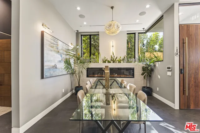 a large kitchen with a table and chairs