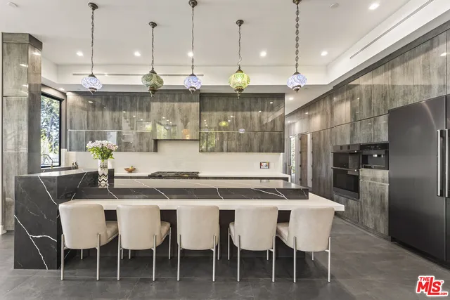 a large kitchen with stainless steel appliances kitchen island granite countertop a lot of counter space