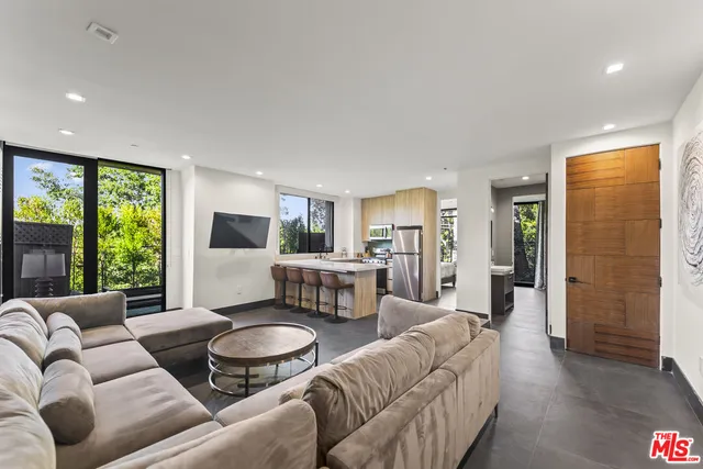 a bedroom with a bed and large window