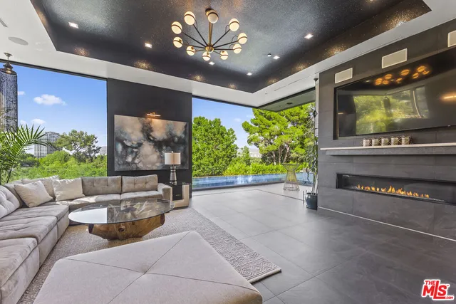 a living room with furniture and a chandelier