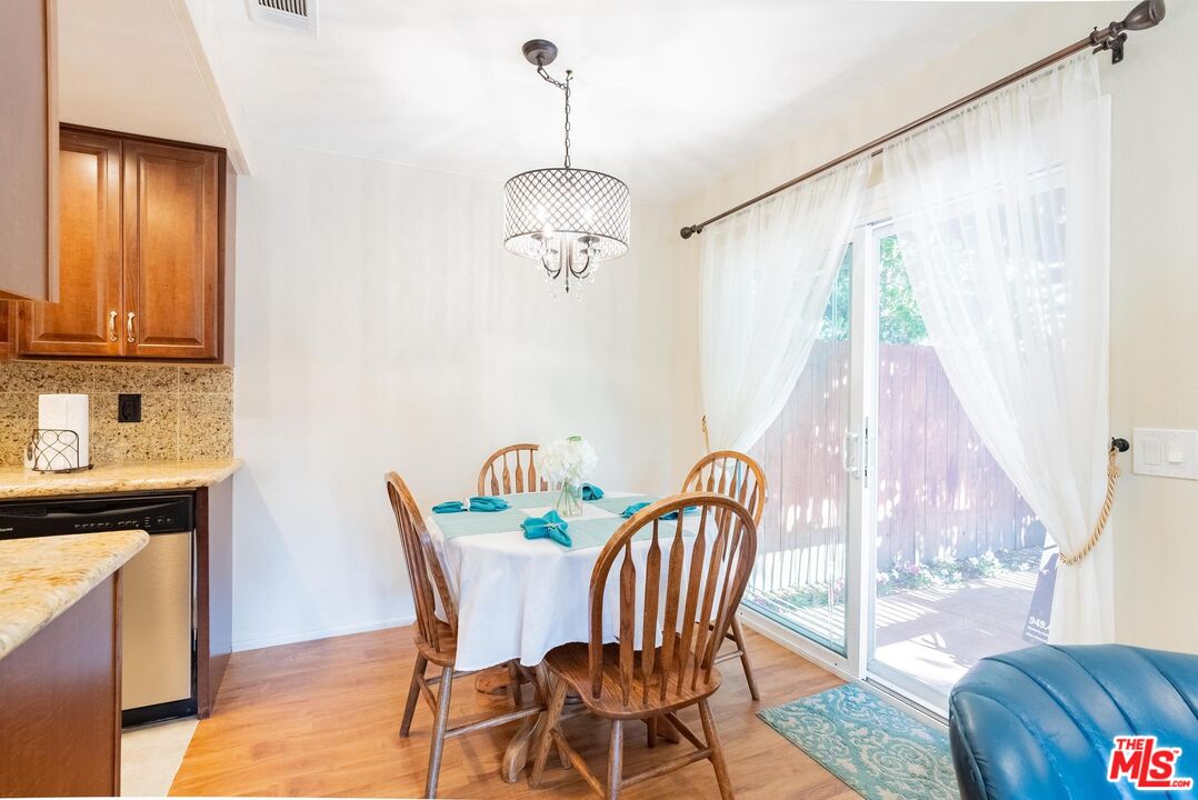2567 Grambling Lane Riverside, CA 92507 - Photo 11 of 38 a view of a dining room with furniture and wooden floor