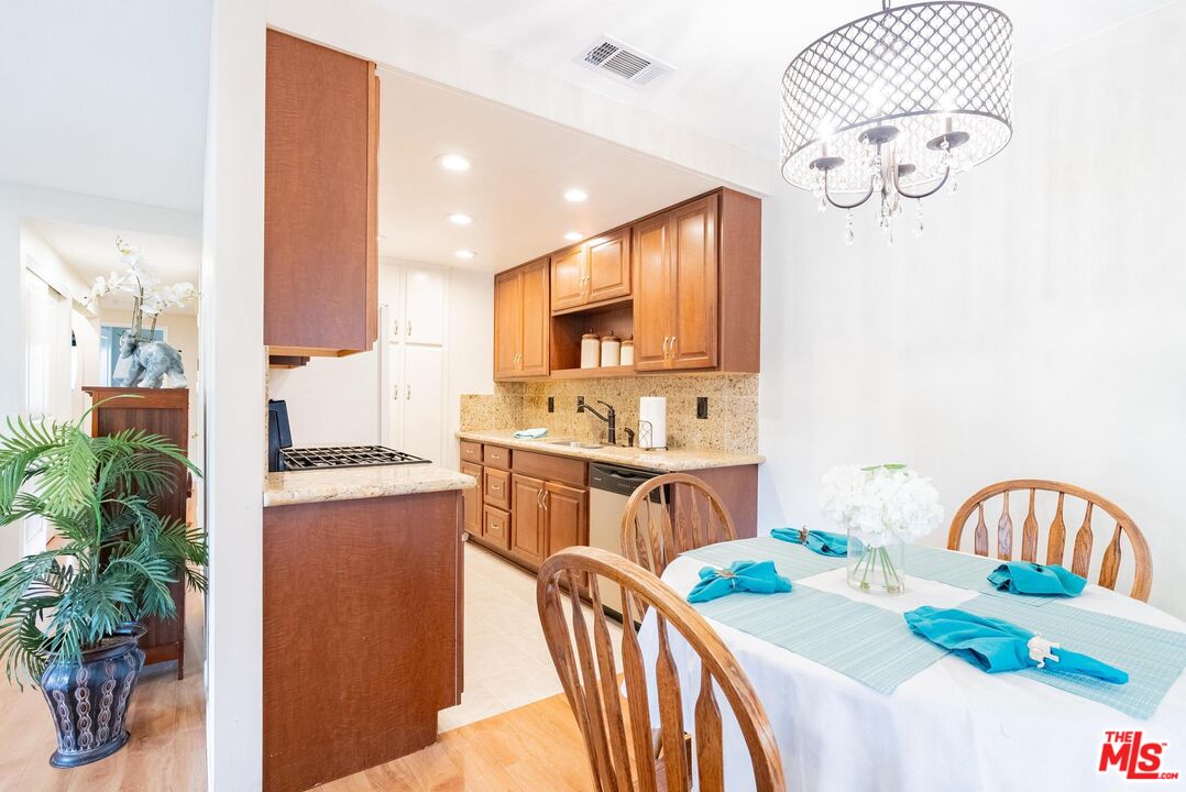 2567 Grambling Lane Riverside, CA 92507 - Photo 12 of 38 a kitchen that has a lot of cabinets a sink and a stove