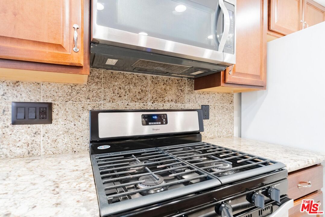 2567 Grambling Lane Riverside, CA 92507 - Photo 14 of 38 a stove top oven sitting inside of a kitchen