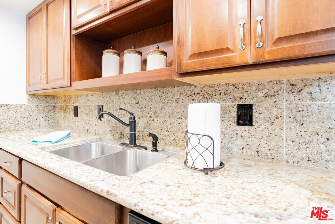 2567 Grambling Lane Riverside, CA 92507 - Photo 15 of 38 a kitchen with granite countertop a sink a stove and a window