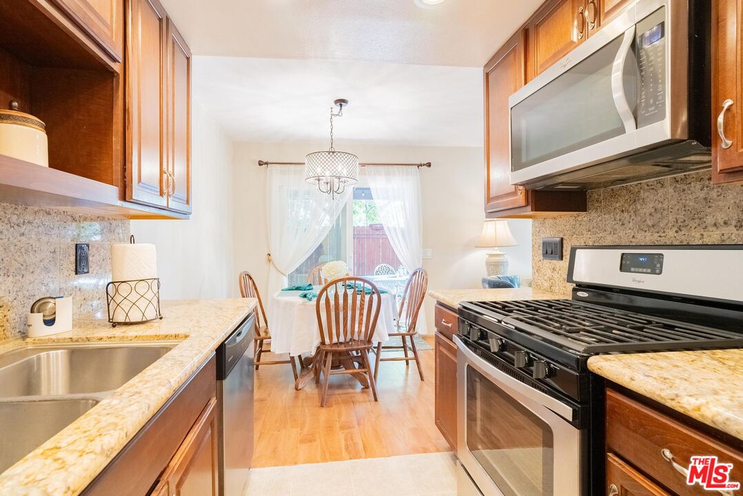 2567 Grambling Lane Riverside, CA 92507 - Photo 16 of 38 a kitchen with a stove a sink and a microwave