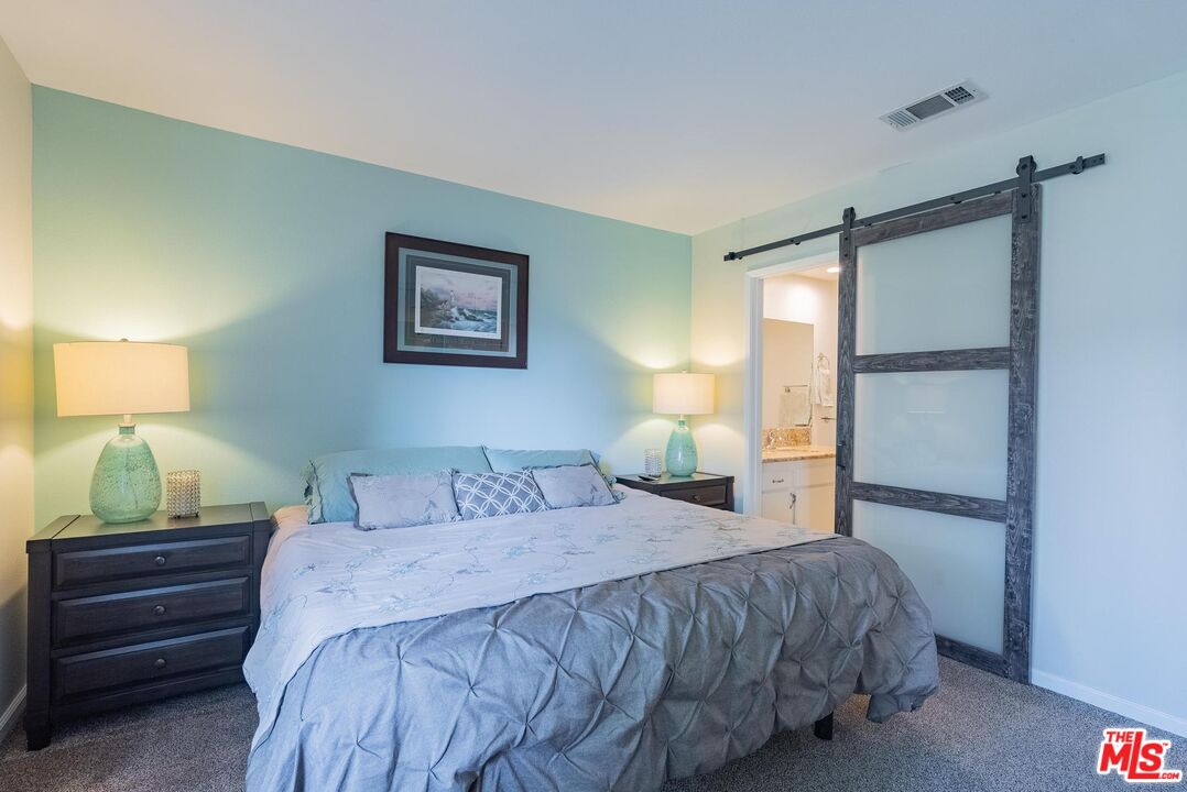 2567 Grambling Lane Riverside, CA 92507 - Photo 19 of 38 a bedroom with a bed and a lamp on the dresser