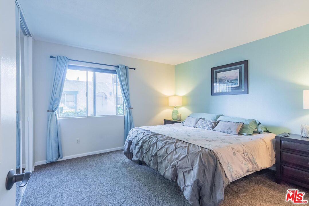 2567 Grambling Lane Riverside, CA 92507 - Photo 20 of 38 a bedroom with a bed and a window