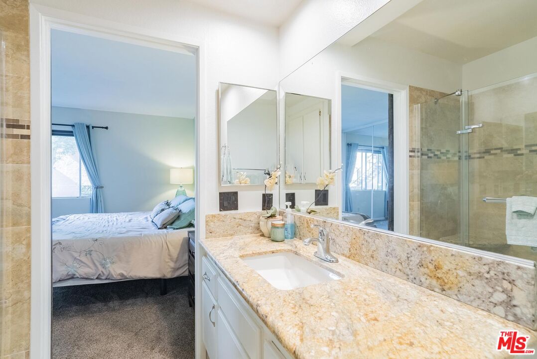 2567 Grambling Lane Riverside, CA 92507 - Photo 22 of 38 a bathroom with a granite countertop sink and a mirror