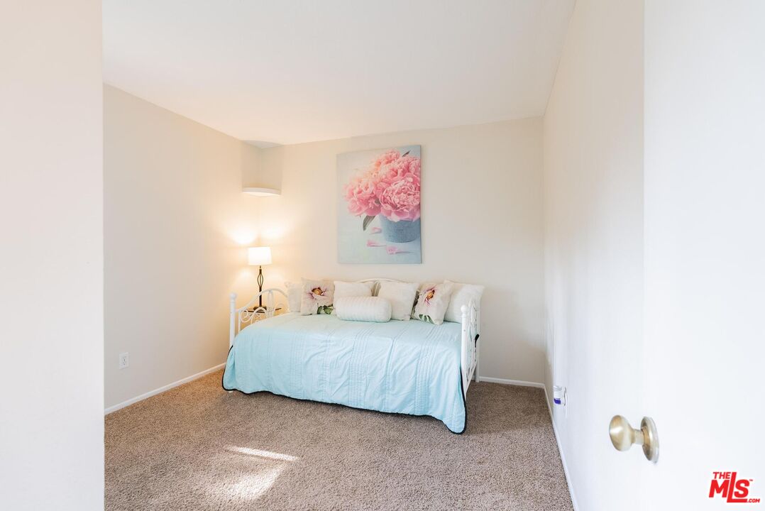 2567 Grambling Lane Riverside, CA 92507 - Photo 24 of 38 a bedroom with a bed and a painting on the wall