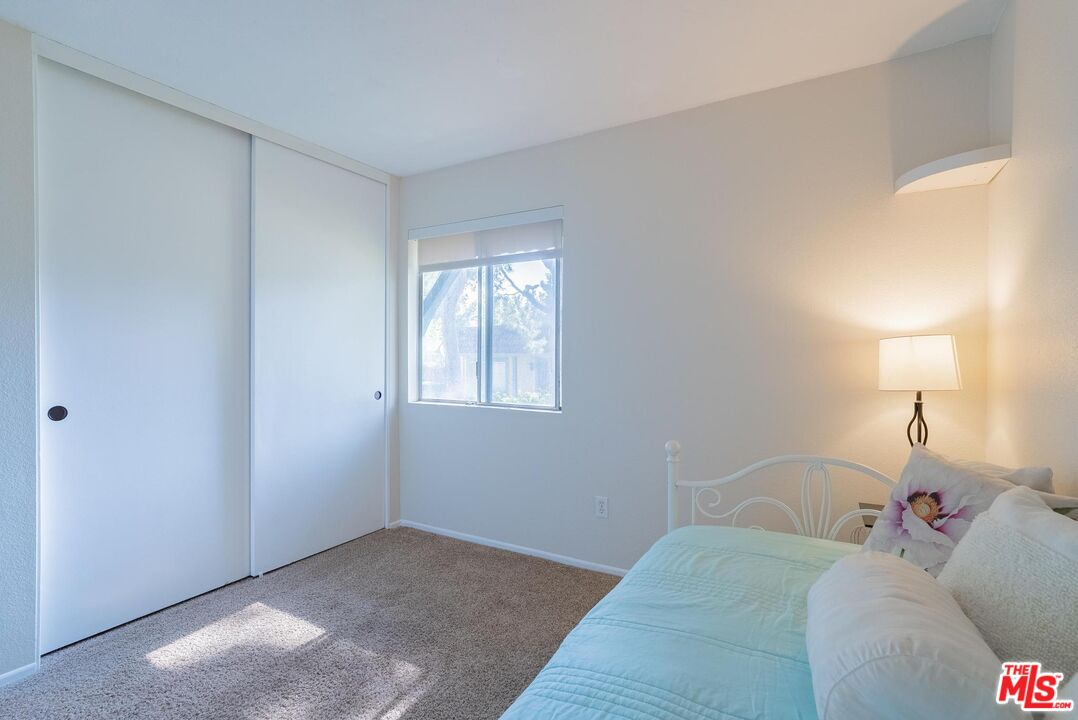 2567 Grambling Lane Riverside, CA 92507 - Photo 25 of 38 a bedroom with a bed and a window