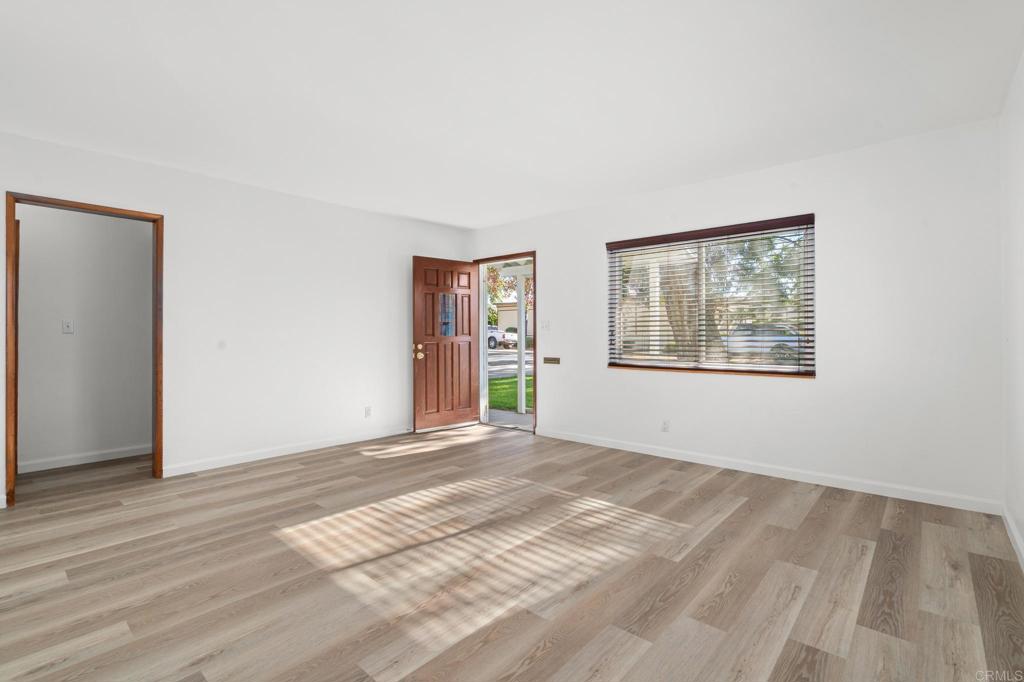 549 D Street Ramona, CA 92065 - Photo 11 of 44 a view of an empty room with window and wooden floor