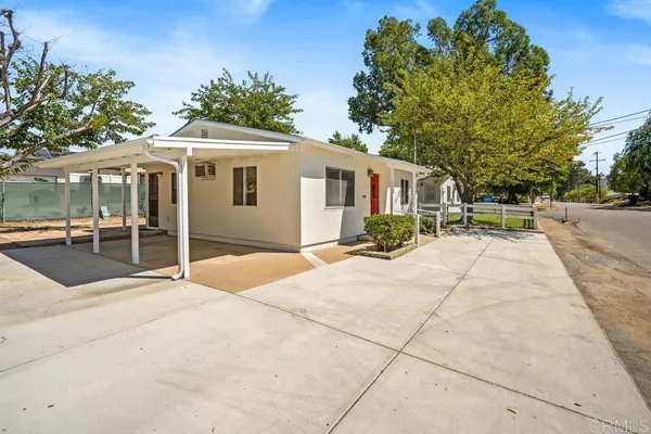a backyard of a house with yard and outdoor seating