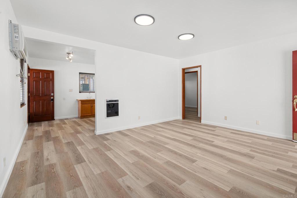 549 D Street Ramona, CA 92065 - Photo 22 of 44 a view of empty room with a fireplace and wooden floor