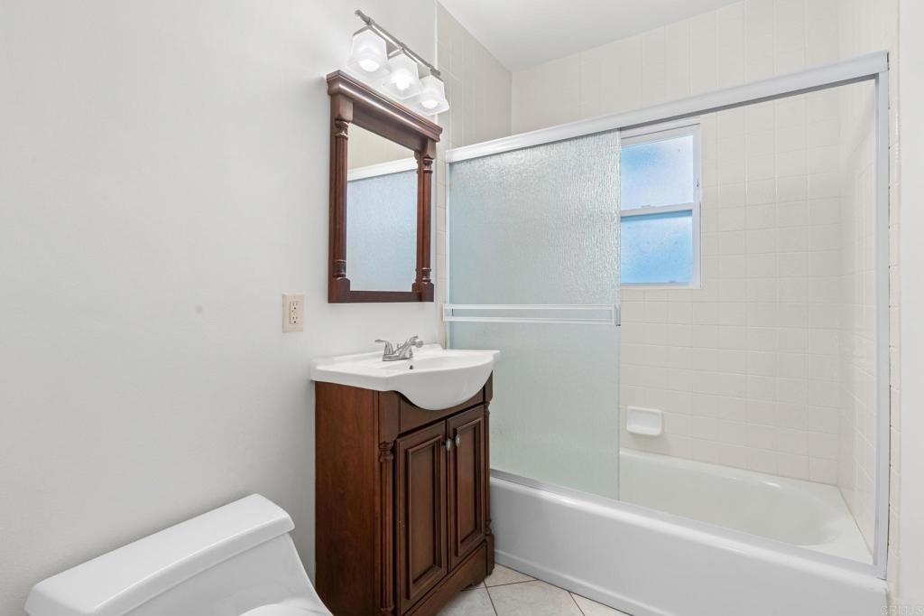 549 D Street Ramona, CA 92065 - Photo 25 of 44 a bathroom with a sink a mirror and a bathtub