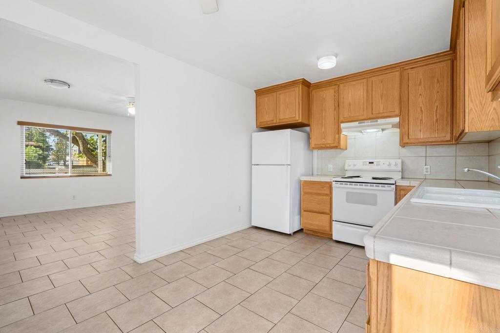 549 D Street Ramona, CA 92065 - Photo 32 of 44 a kitchen with a stove a sink and a microwave