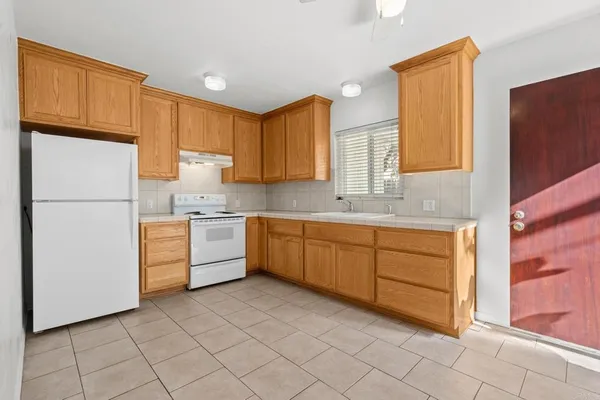 a kitchen with cabinets stainless steel appliances and a window