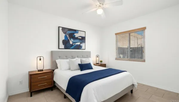 a bedroom with a bed and a painting on the wall