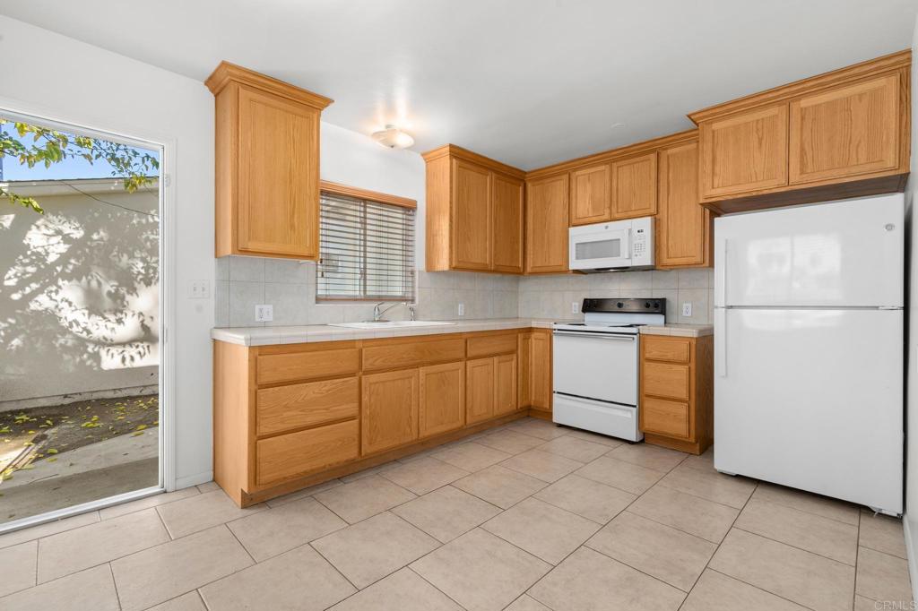 549 D Street Ramona, CA 92065 - Photo 9 of 44 a kitchen with a white cabinets and white appliances