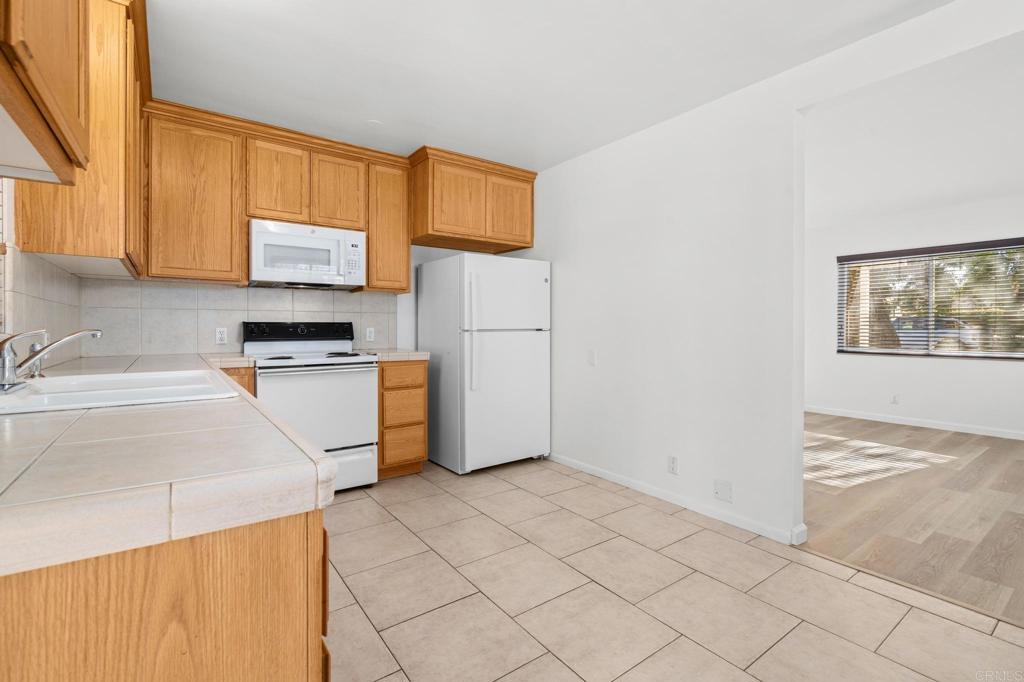 549 D Street Ramona, CA 92065 - Photo 10 of 44 a kitchen with a refrigerator sink and cabinets