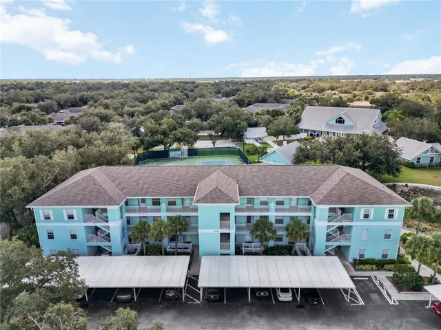 an aerial view of house with yard and mountain view in back