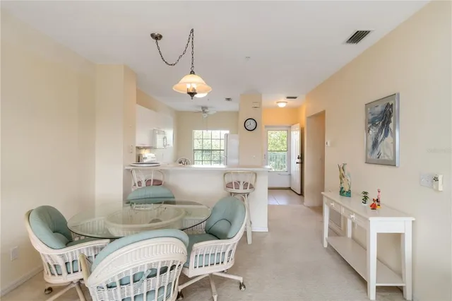 a living room with furniture and a dining table