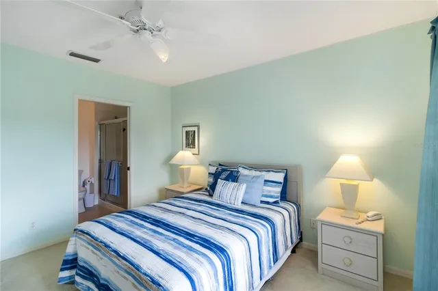 a bedroom with a bed and a lamp