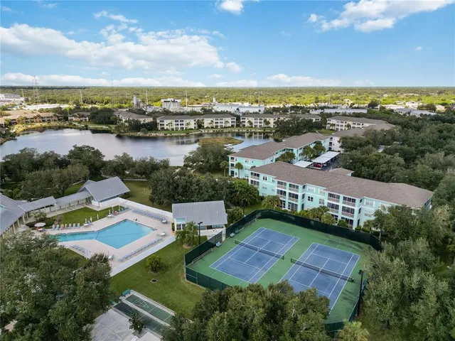 an aerial view of residential houses with outdoor space and ocean