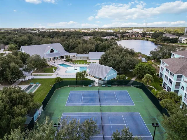an aerial view of a tennis ground and a houses