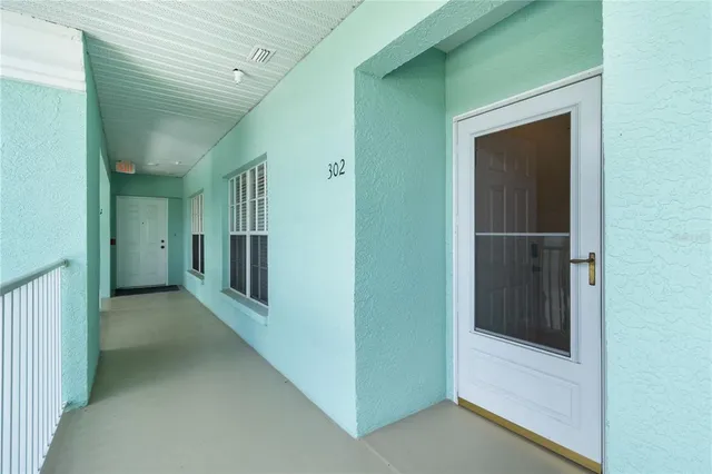 a view of a hallway with wooden shelves